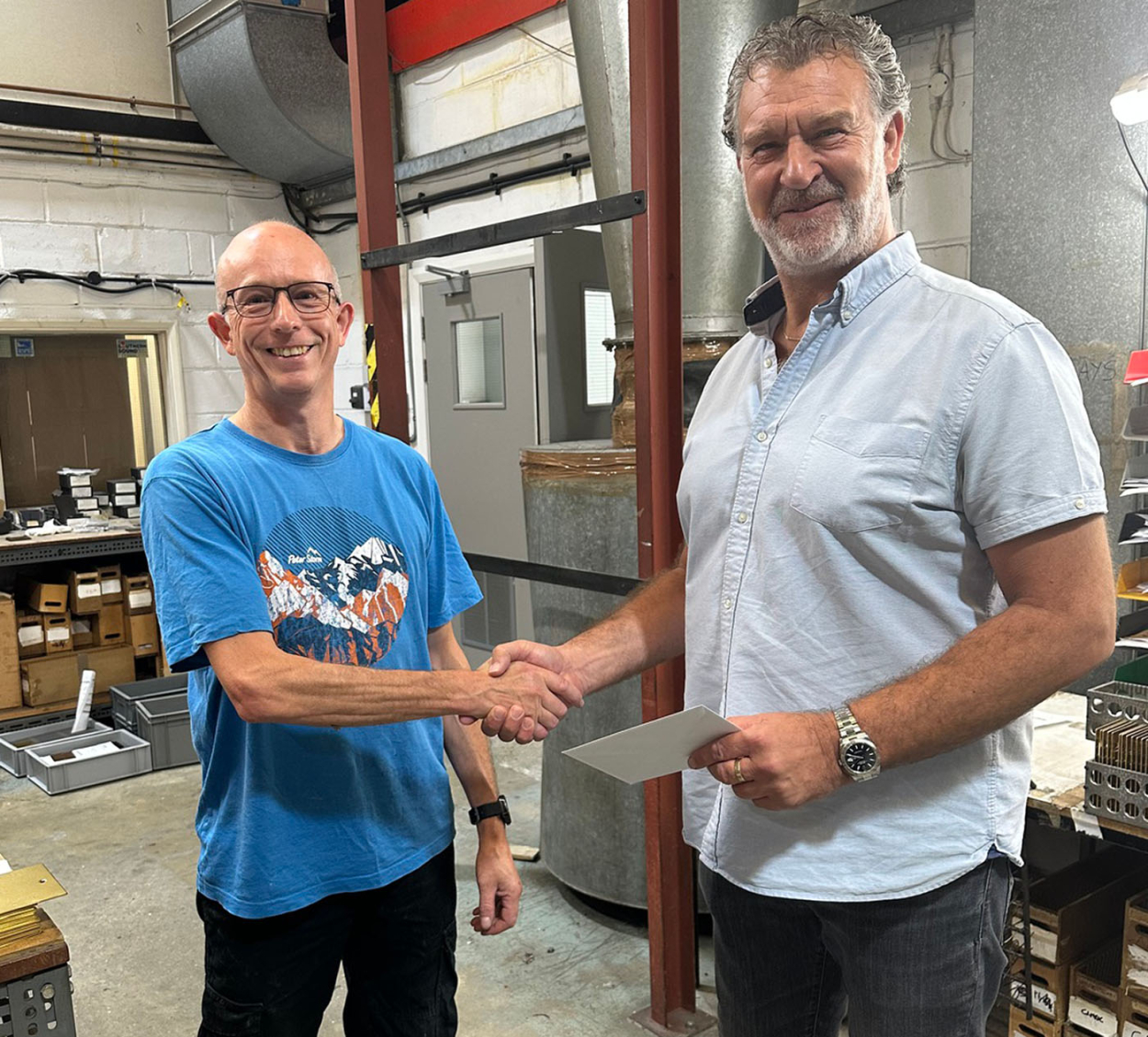 Gary (right) presents Trevor Saunders with his holiday voucher.